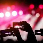 silhouette-hands-using-smartphones-take-pictures-videos-live-music-show
